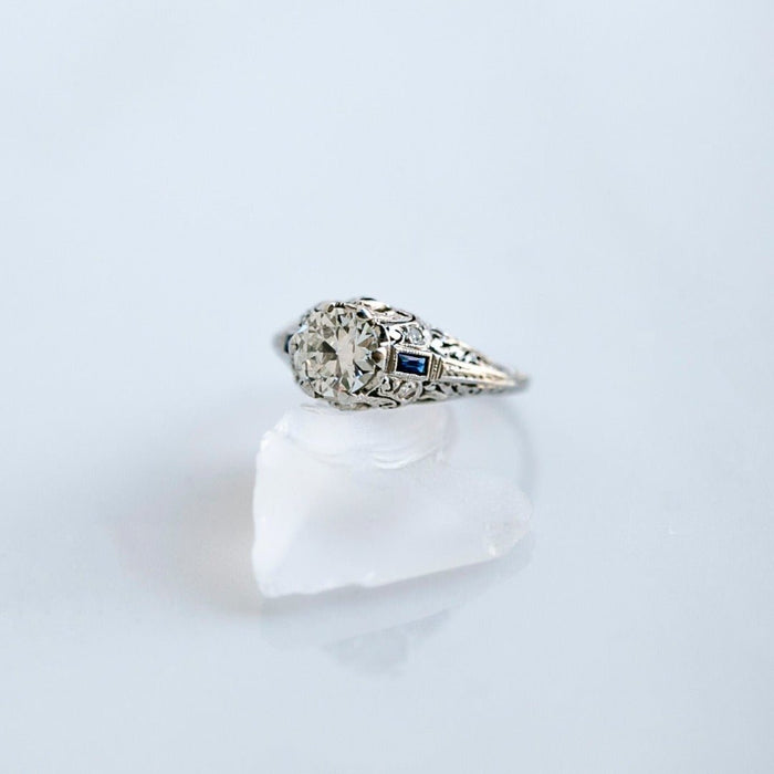 A Beautiful Art Deco Bombe Style Platinum, Diamond and Synthetic Sapphire Ring